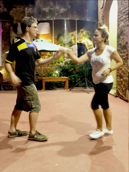 Two people salsa dancing.